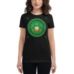 A person wears a black t-shirt featuring a green circular design with the text "HAPPY ST. PATRICK'S DAY" and an illustration of a leprechaun and shamrocks  celebrating St. Patrick's Day.