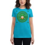 A person wears a bright blue t-shirt featuring a circular green design with the text Happy St. Patrick's Day and a leprechaun illustration surrounded by four-leaf clovers