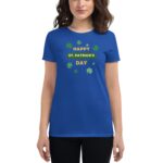 A blue t-shirt displays the text "HAPPY ST. PATRICK'S DAY" surrounded by green shamrocks worn by a person in a neutral setting.