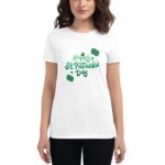 A woman is wearing a white t-shirt that features the text Happy St. Patrick's Day in green with decorative elements  suggesting a festive celebration for the holiday.