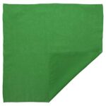 A square green cloth is neatly folded at one corner with a slight diagonal edge visible resting on a flat surface  evoking a simple and vibrant textile scene.