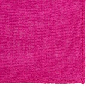 A bright pink fabric occupies the foreground with a clean edge visible on one side showcasing a smooth texture and vibrant color suggesting it is new or freshly laundered.