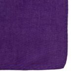 A purple fabric piece lies flat showcasing a smooth texture with a neatly stitched edge set against a plain background emphasizing its vibrant color and quality craftsmanship