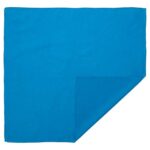 A solid blue square cloth is laid flat with one corner folded over itself  creating a sharp triangular edge. The surface appears smooth and vibrant in color.