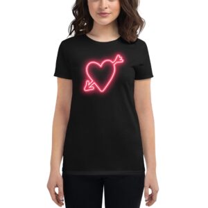 A person wears a black t-shirt featuring a neon pink heart design with an arrow through it  standing against a plain background  highlighting the shirt's graphic element.