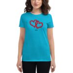 A turquoise t-shirt displays a graphic of two intertwined red hearts made of roses with the year 2024 beneath it  worn by a woman in a neutral background.
