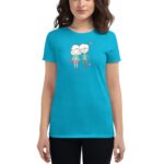 A woman wearing a bright blue t-shirt features a colorful graphic of two cartoon characters with hearts around them  symbolizing affection in a casual setting.