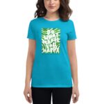 A woman is wearing a bright turquoise t-shirt featuring a green graphic design with the text "DO WHAT MAKES YOU HAPPY" and "HAPPY ST. PATRICK’S DAY" in a festive style.