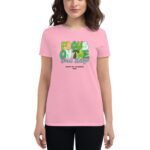 A woman wears a pink t-shirt featuring colorful text that reads FOCUS ON THE Good Things with a St. Patrick's Day theme in black lettering below stating HAPPY ST. PATRICKS 2024.