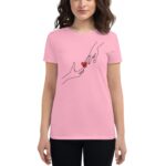 A woman wearing a pink T-shirt is reaching out with one hand towards an illustrated hand  both hands are outlined in black and a small red heart is centered between them.