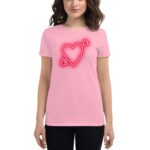 A young woman wears a pink t-shirt featuring a neon red heart with an arrow through it in the center against a plain white background.