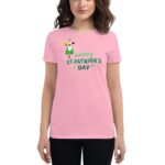 A woman wears a pink t-shirt featuring a cartoon character and text celebrating St. Patrick's Day creating a festive atmosphere suitable for the holiday.