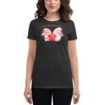 A woman is wearing a dark gray t-shirt featuring two cartoon gnomes holding a heart with the word "LOVE" on it and the text "A love like gnome other" above them.