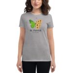 A woman is wearing a gray t-shirt featuring a green butterfly and yellow sunflowers with text that says St. Patrick it's a Lucky Day against a neutral background.
