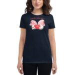 A woman wears a navy t-shirt featuring two gnomes holding a red heart with the text A love like gnome other Love in a playful design.