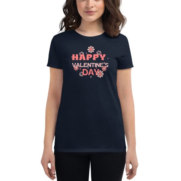 A woman wears a dark t-shirt featuring the text "HAPPY VALENTINE'S DAY" in pink with floral decorations  indicating a festive theme for Valentine's Day.