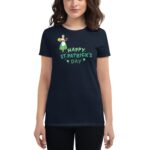 A dark t-shirt features a cheerful graphic of a character celebrating with festive symbols and the text "HAPPY ST. PATRICK'S DAY " conveying a joyful St. Patrick's Day theme.