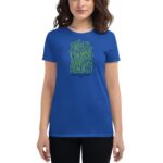 A woman is wearing a blue t-shirt featuring decorative green text that reads "YOU HAVE THE COURAGE TO BEGIN AGAIN HAPPY ST. PATRICKS 2024" against a plain background.