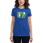 A woman wears a blue t-shirt featuring colorful text that reads FOCUS ON THE Good Thynks with the words HAPPY ST. PATRICKS 2024 below the main phrase