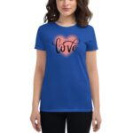 A blue t-shirt displays the word love in a stylized font inside a heart outline with a soft glow effect while being worn by a person with medium-length hair in a neutral setting.