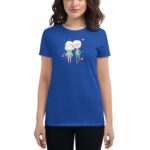 A woman wears a blue t-shirt featuring a playful illustration of two cartoon characters standing together surrounded by hearts against a plain background.