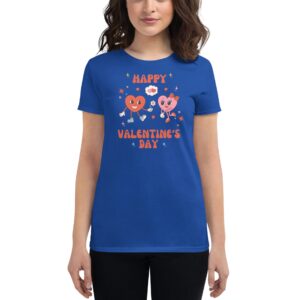 A woman wears a blue t-shirt featuring cartoon hearts with arms and legs holding flowers and balloons with the text Happy Valentine's Day in colorful letters set against a festive background.