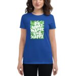 A person wears a blue t-shirt featuring a green and white graphic that says DO WHAT MAKES YOU HAPPY with smiley faces and decorative elements in a casual setting.