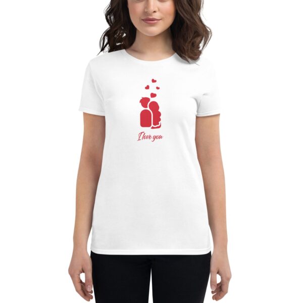 A woman is wearing a white t-shirt featuring a red graphic of two figures embracing with hearts above and the text I love you below  conveying a romantic theme.