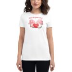 A woman is wearing a white t-shirt featuring a colorful graphic of two gnomes with a heart that says "Love" and the text "A love like gnome other" above them.