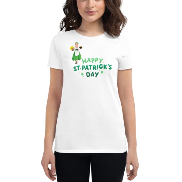 A woman wears a white t-shirt with a colorful graphic of a character and the text "HAPPY ST.PATRICK'S DAY" celebrating the holiday's festive spirit in a casual setting.