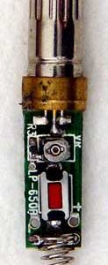 An image of a laser diode with a contact spring and momentary switch attached.