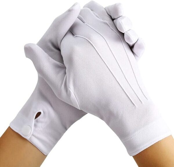 Two white gloves are clasped together in a gesture of unity or greeting set against a plain white background highlighting their soft fabric and smooth texture.