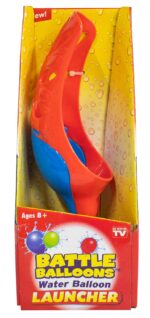 A red and blue water balloon launcher is displayed in a brightly colored packaging featuring water droplets and colorful balloon graphics with the text Battle Balloons Water Balloon Launcher and Ages 8+