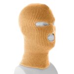 A knitted balaclava in a tan color is displayed on a mannequin head with openings for the eyes and mouth set against a neutral background.