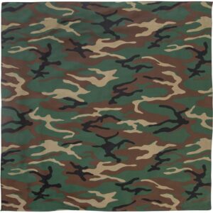 A patterned fabric features a camouflage design with green brown and black swirls and shapes creating a textured appearance ideal for military or outdoor contexts.