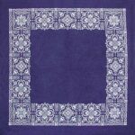 A navy blue cloth serves as the base featuring intricate white floral patterns arranged in a border around a plain central area creating a decorative frame effect.