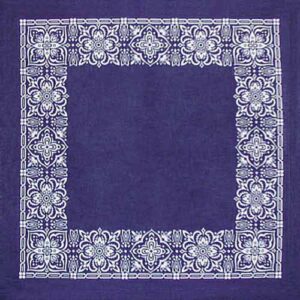A navy blue cloth serves as the base featuring intricate white floral patterns arranged in a border around a plain central area creating a decorative frame effect.