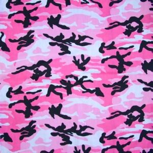 A pink camouflage fabric features abstract black shapes intertwined among varying shades of pink and white creating a bold and playful pattern suitable for fashion or design projects.