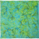 A vibrant fabric displays an intricate pattern of swirling flowers and dots in shades of blue and green with highlights of yellow set against a smooth background.