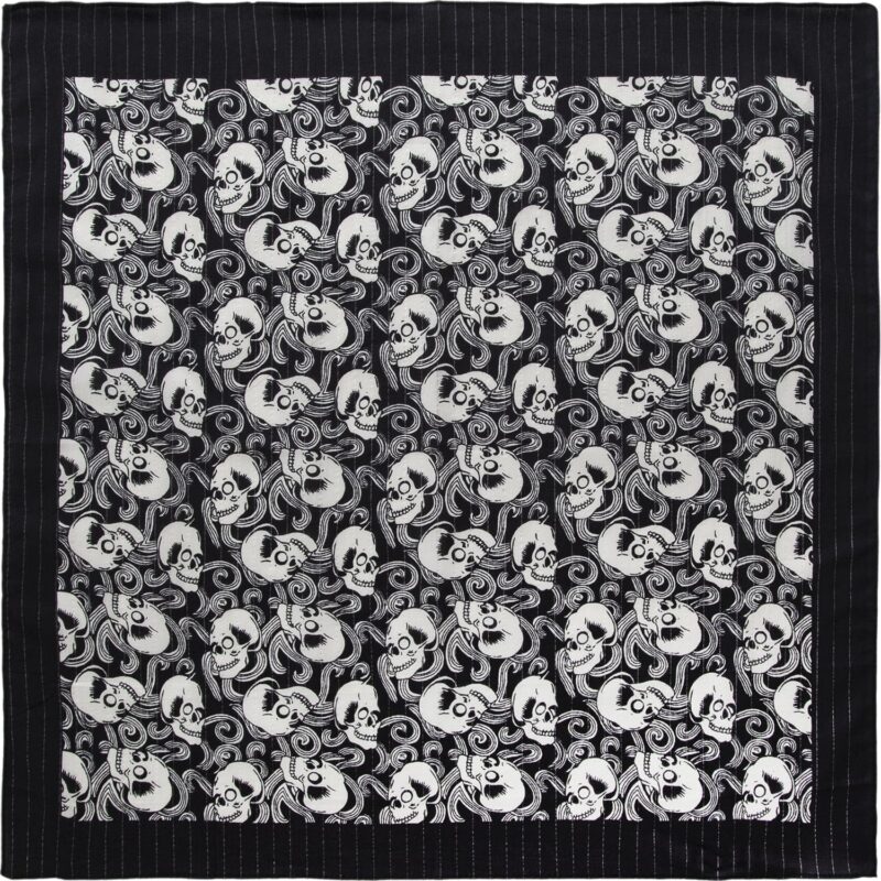 Skulls Lurex Paisley - Black Metallic Bandana - 22x22 Inch A patterned fabric displays an intricate design of alternating skulls and swirling elements in black and white creating a striking visual effect against a black background.