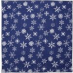 A fabric square featuring various white snowflake patterns scattered across a dark blue background  creating a wintry festive aesthetic suitable for seasonal decorations or table settings.