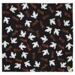 A black fabric features repeated white ghost silhouettes and the word "Boo!" in orange  creating a playful Halloween-themed design suitable for decorations or apparel.