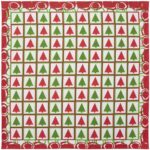 A patterned fabric features alternating rows of red and green Christmas trees within squares surrounded by a white background and a decorative red border with circular motifs.