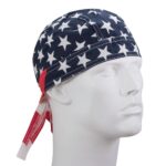 A fabric cap featuring a navy background with large white stars and red accents rests on a mannequin head in a neutral setting  suggesting a patriotic theme.
