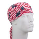 A bandana made of fabric featuring a pattern of American flags wraps around a mannequin head while facing slightly to the right in a neutral setting.