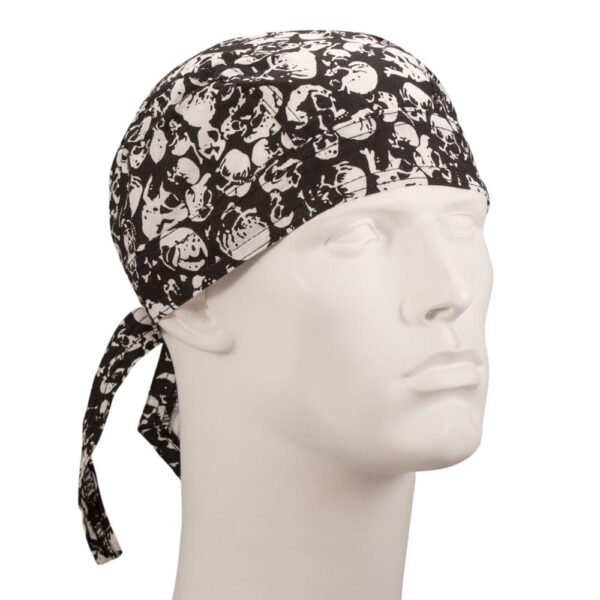 A black and white bandana with a skull pattern is tied around a mannequin's head showcasing a stylish accessory in a simple indoor setting highlighting fashion or costume elements