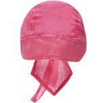 A bright pink head covering with a rounded top and ties hangs freely displaying its smooth fabric and lightweight design in a neutral background.