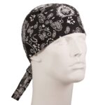 A black bandana with white paisley patterns is tied around a mannequin's head facing slightly to the side in a neutral setting highlighting the headwear's design and style.