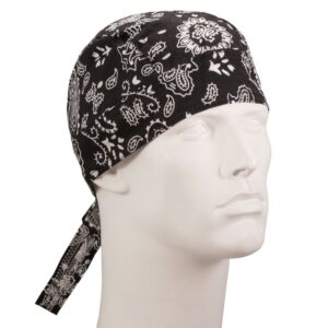A black bandana with white paisley patterns is tied around the head of a mannequin displaying a neutral expression in a plain  softly lit environment