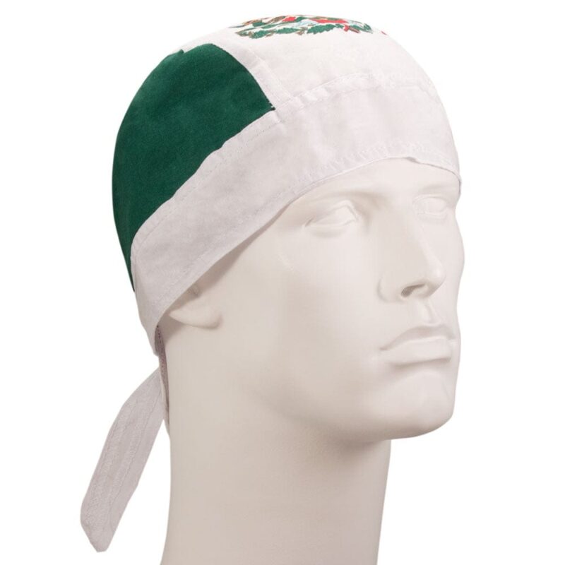 A white and green bandana is worn on a mannequin head showcasing its design. The bandana features colors and patterns that may represent cultural significance.